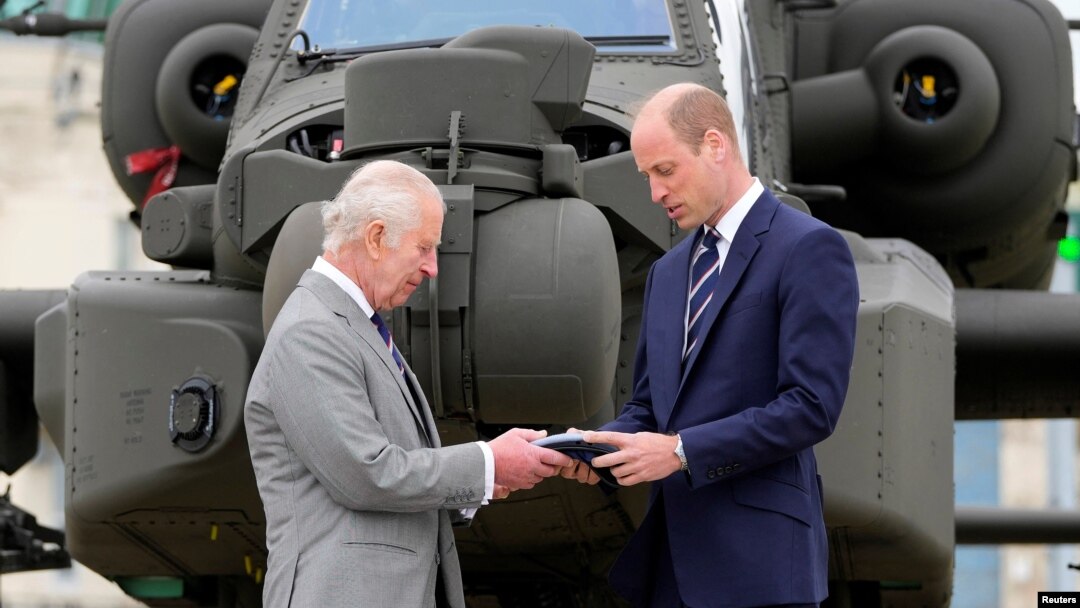 Britain's King Charles III officially hands over the role of Colonel-in-Chief of the Army Air Corps to Prince William, in front of a helicopter at the Army Aviation Centre in Middle Wallop, Britain, May 13, 2024.