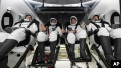 Left to right, Roscosmos cosmonaut Andrei Fedyaev, NASA astronaut Warren "Woody" Hoburg, NASA astronaut Stephen Bowen, and UAE astronaut Sultan al-Neyadi are seen after landing off the coast of Jacksonville, Florida, Sept. 4, 2023. (NASA via AP)