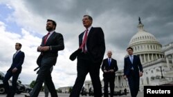 FILE - U.S. senators walk to a press conference to call on U.S. President Joe Biden to negotiate with Republicans in order to make a deal on raising the debt ceiling on Capitol Hill, May 3, 2023. Biden, House Speaker Kevin McCarthy and others are meeting May 16 for further talks.