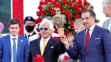 FILE - Bob Baffert, center, holds the trophy after Medina Spring won the 147th Kentucky Derby in Louisville, Ky., on May 1, 2021, but then failed a post-race drug test that led to a suspension for Baffert, the horse's trainer. (Jim Owens-USA Today Sports via Reuters)
