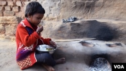 A young tribal girl in Jharkhand sits down for a meal. Impoverished and starved, girls from tribes in remote parts of India often become targets for human traffickers. (Arti Munda for VOA)