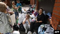 FILE - Local residents wait to be evacuated outside of the town of Sudzha. Aug. 8, 2024. (Photo by Anatoliy Zhdanov / Kommersant Photo / AFP).