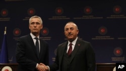 Turkey's Foreign Minister Mevlut Cavusoglu, right, and NATO Secretary-General Jens Stoltenberg are pictured after a press conference in Ankara, Turkey, Feb. 16, 2023.