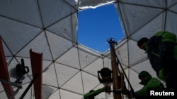 Members of the Ice Memory Foundation work to drill down into the ice and collect two ice cores, at 1,100 meters (3,600 feet) above sea level in the Holtedahlfonna icefield, April 10, 2023.