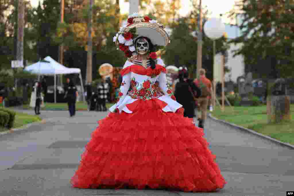 A reveler celebrates Dia De Los Muertos (Day of the Dead) at Hollywood Forever Cemetery in Los Angeles, California, Oct. 28, 2023.