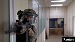 FILE - A gendarme of the French National Gendarmerie Intervention Group (GIGN) takes part in a drill, as part of the preparation for the upcoming Paris 2024 Olympic Games, near Paris, April 26, 2024.