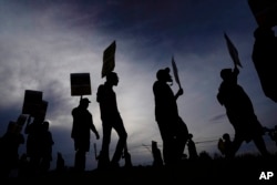 FILE - UPS teamsters and workers hold a rally, July 21, 2023, in Atlanta, Georgia, as a national strike deadline nears.