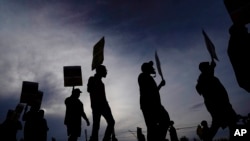 FILE - UPS teamsters and workers hold a rally, July 21, 2023, in Atlanta, Georgia, as a national strike deadline nears.