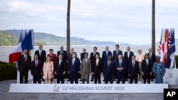 World leaders from G7 and invited countries, and organizations pose for a family photo during the G7 Leaders' Summit in Hiroshima, Japan, May 20, 2023.