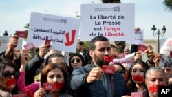 FILE - Journalists in Tunis, Tunisia, protest the threat of danger the press faces and the return to the country's dictatorship, especially after the arrest of the general manager of Radio Mosaique Noureddine Boutar, Feb. 16, 2023.