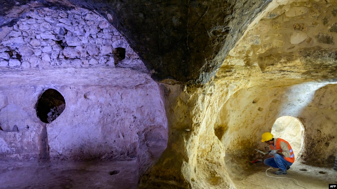 Municipal employees work inside the Matiate archaeological site underneath the town in Midyat in Mardin province, southeastern Turkey, July 1, 2024.
