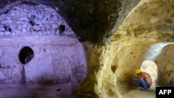 Municipal employees work inside the Matiate archaeological site underneath the town in Midyat in Mardin province, southeastern Turkey, July 1, 2024.