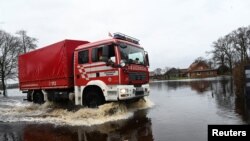 Firefighters of the city of Bremen drive through flooded streets following heavy rainfalls in Lilienthal near Bremen, northern Germany, Dec. 28, 2023. 