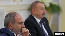 FILE - Armenia's Prime Minister Nikol Pashinyan, left, and Azerbaijan's President Ilham Aliyev attend a meeting of heads of the Commonwealth of Independent States in Ashgabat, Turkmenistan, October 11, 2019. The two will meet May 14, 2023, in Brussels.