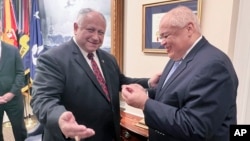 Thurgood Marshall Jr., right, smiles as he receives the first pen from Navy Secretary Carlos Del Toro, at the Pentagon in Washington, July 17, 2024.