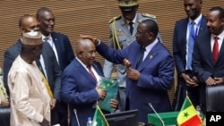 Comoros President Azali Assoumani, center, is appointed as the new African Union chairperson, in Addis Ababa, Ethiopia, Feb. 18, 2023, during the African Union Summit.