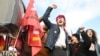 FILE - Protesters raise their fists and shout during a demonstration on the day of a ruling from France's Constitutional Council on a contested pension reform pushed by the French government, in Nantes, France, on April 14, 2023.