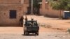 Sudanese army soldiers rest next to a building in Khartoum on May 25, 2023. Fighting eased in Sudan, the second full day of a ceasefire that has allowed beleaguered civilians to venture out, even as they await safe aid corridors and escape routes. 