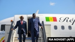 Senegal's President Macky Sall (R) and Comoros President Azali Assoumani (L) arriving at Pulkovo airport in Saint Petersburg to attend the Saint Petersburg International Economic Forum on June 17, 2023. 