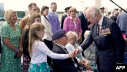 Britain's King Charles III meets D-Day veteran Eric Bateman and members of his family, following the UK's national commemorative event to mark the 80th anniversary commemorations of D-Day In France, in Southsea Common, southern England, June 5, 2024.