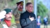 In this handout picture taken and released by Pakistan Prime Minister's Office on March 4, 2024, Pakistan's newly sworn-in Prime Minister Shehbaz Sharif, right, inspects the guard of honor at the Prime Minister House in Islamabad. 
