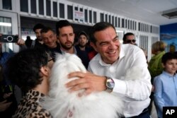 Leader of the main opposition Syriza party, Alexis Tsipras greeting his supporters at a polling station in Athens, Greece, May 21, 2023.