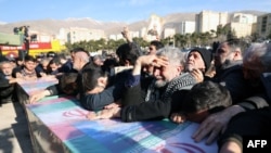 Mourners attend the funeral of Iranian Revolutionary Guard Corps (IRGC) members killed January 20 in Damascus in a strike blamed on Israel, in the Iranian capital of Tehran on Jan. 22, 2023. 