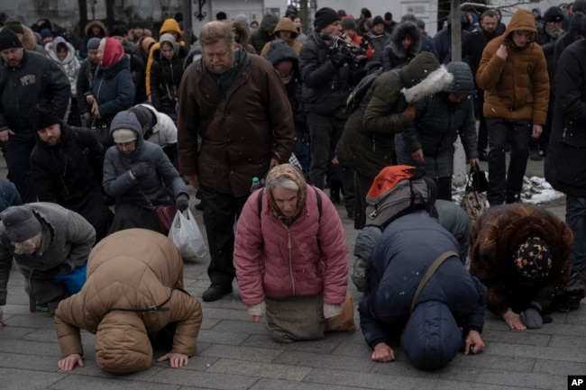 People pray in the Kyiv Pechersk Lavra monastery complex in Kyiv, Ukraine, March 29, 2023. (AP Photo/Andrew Kravchenko)