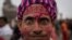 A Hindu devotee reacts as he arrives ahead of the opening of the grand temple of Lord Ram in Ayodhya in India.