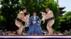 Amateur sumo wrestlers hold babies during 'Nakizumo' or a baby-crying sumo contest, at Sensoji temple in Tokyo, Japan, April 28, 2024. 