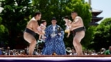 Amateur sumo wrestlers hold babies during 'Nakizumo' or a baby-crying sumo contest, at Sensoji temple in Tokyo, Japan, April 28, 2024. 