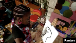 FILE- Screengrab shows Christine Nnaji painting in her art studio in Lagos, Nigeria (undated).