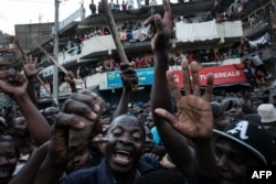 FILE - Supporters react as Raila Odinga, not pictured, speaks during a protest in Nairobi on March 20, 2023.