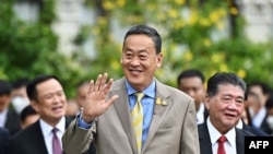 FILE - Thailand Prime Minister Srettha Thavisin waves to reporters as he walks with fellow cabinet members to the first official cabinet meeting at Government House in Bangkok on September 6, 2023.