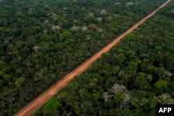 FILE - Aerial view of a preserved Amazonia rainforest area with the federal highway BR-230, popularly known as Transamazonica, crossing the indigenous community Aldeia Tenharin Marmelo, Amazonas state, Brazil, Sept. 18, 2022.