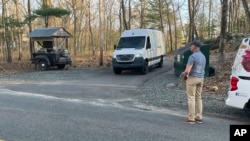 Federal officials leave the property where Jack Teixeira, a Massachusetts Air National Guard member, was taken into custody in Dighton, Mass., Thursday, April 13, 2023. (AP Photo/Jennifer McDermott)