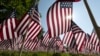 FILE - The sun shines through the flags in the Memorial Day Flag Garden on Boston Common, in Boston, May 27, 2023. 