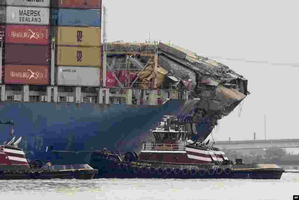 Tugboats escort the cargo ship Dali after it was refloated in Baltimore, Maryland.&nbsp;The vessel on March 26 struck the Francis Scott Key Bridge causing it to collapse and resulting in the death of six people.