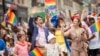 FILE - Prime Minister Justin Trudeau waves to the crowd as he, his wife Sophie Gregoire Trudeau and their children Xavier and Ella-Grace march in the Pride Parade in Toronto, June 25, 2017. 