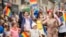 FILE - Prime Minister Justin Trudeau waves to the crowd as he, his wife Sophie Gregoire Trudeau and their children Xavier and Ella-Grace march in the Pride Parade in Toronto, June 25, 2017. 