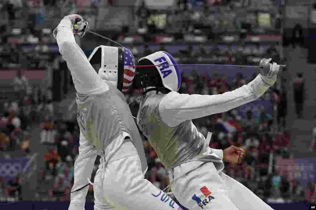 United State&#39;s Gerek Meinhardt, left, and France&#39;s Enzo Lefort compete in the men&#39;s individual Foil round of 16 competition during the 2024 Summer Olympics at the Grand Palais in Paris, France.