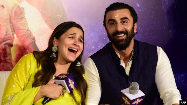 Bollywood actors Alia Bhatt (L) and Ranbir Kapoor gesture during the promotion of their Hindi film