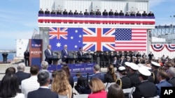 FILE - From left, Australian Prime Minister Anthony Albanese, U.S President Joe Biden and British Prime Minister Rishi Sunak speak at an AUKUS event at Point Loma naval base in San Diego, California, March 13, 2023.