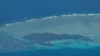 FILE - An aerial view shows the Second Thomas Shoal — and the World War II-era ship grounded on it — in the South China Sea, March 9, 2023.