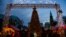 A Christmas tree greets visitors at the entrance to a traditional Christmas market in Berlin, Germany, Dec. 22, 2023, as the Marienkirche church (R) is seen in the background. 