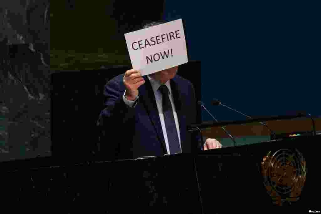 Palestinian U.N. envoy Riyad H. Mansour holds up a sign during a plenary meeting on the &#39;Use of the veto - Item 63: Special report of the Security Council&#39;, in the General Assembly Hall at U.N. headquarters in New York City.