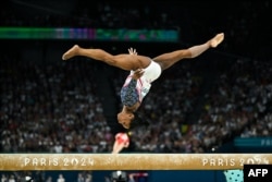 Simone Biles of the U.S. competes in the balance beam event of the artistic gymnastics women's team final during the Paris 2024 Olympic Games at the Bercy Arena in Paris, on July 30, 2024.