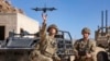 FILE - In this photo from the Defense Visual Information Distribution Service, British soldiers launch a drone during Project Convergence exercises at Fort Irwin, Calif., on Nov. 4, 2022. (DVIDS via AP)