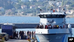 FILE - Migrants disembark from a Greek coast vessel after a rescue operation, at the port of Mytilene, on the northeastern Aegean Sea island of Lesbos, Greece, Aug. 28, 2023.