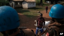 FILE - U.N. peacekeepers patrol the town of Bangassou, Central African Republic, Feb. 15, 2021, amid attacks by armed groups in the region.
